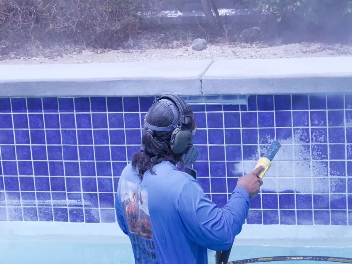 Media blasting calcium off blue waterline tile
